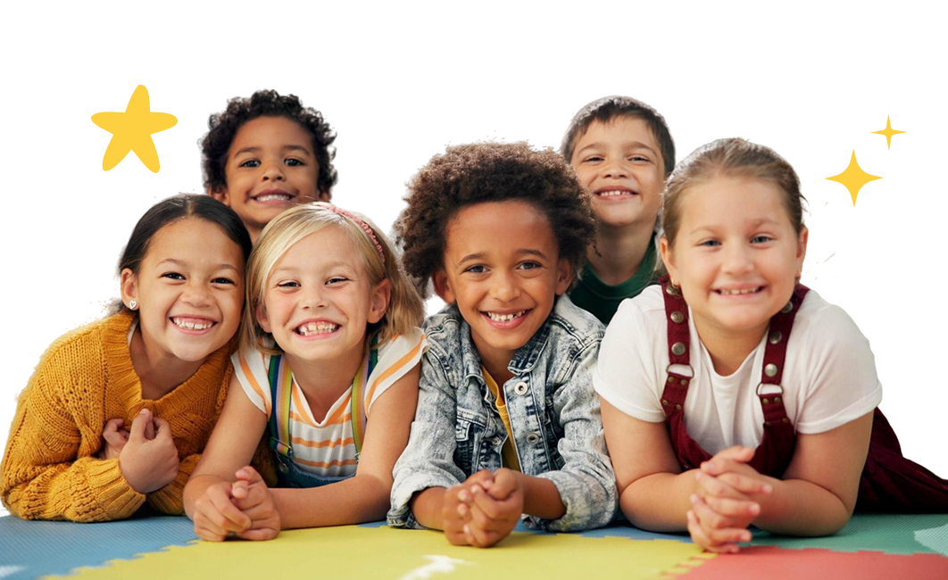 Six young athletes lying on a gym floor smiling at the camera